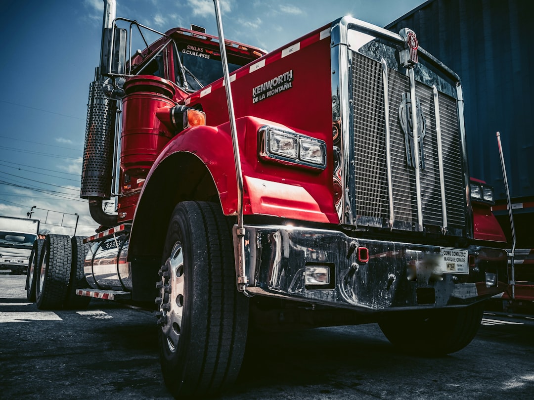 Mechanic working on a semi truck tractor in a Yuma, AZ yard